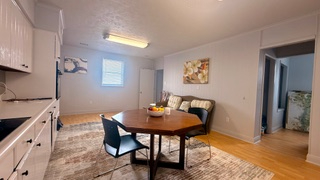 Charming 3-bedroom, 2-bath apartment with a private outdoor porch and stunning sunset views. Ideally - Photo 2