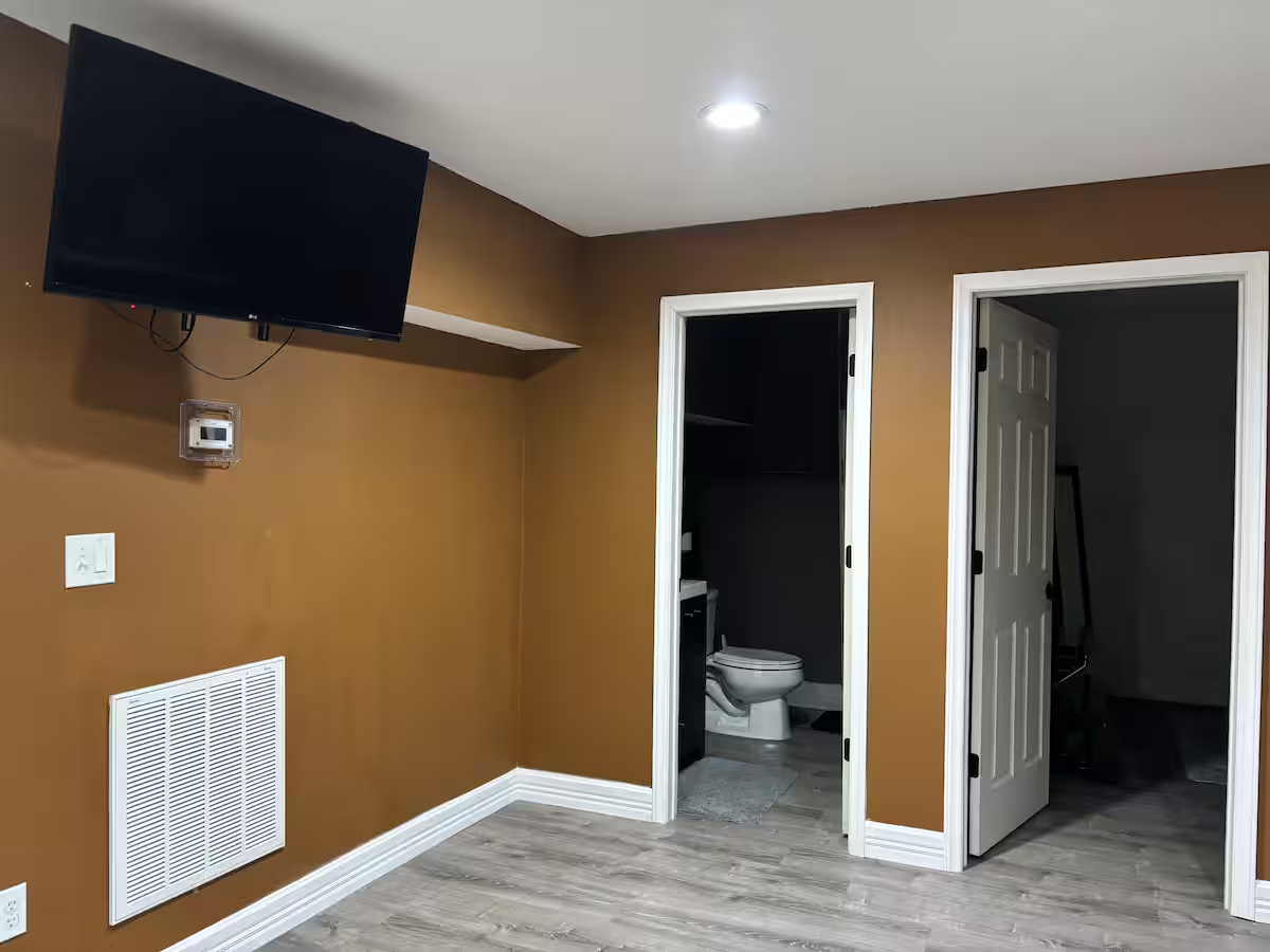 Comfortable Furnished Basement Retreat With Projector And Private Living Space - Photo 11