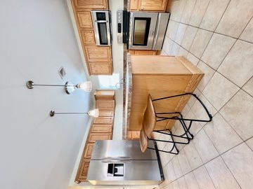 Bright room with hardwood floors, patio, parking, and easy transit access