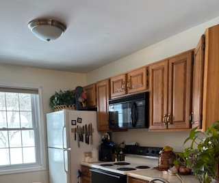 Comfortable end unit two-bedroom condo with garage, sunroom, and community pool access - Photo 2